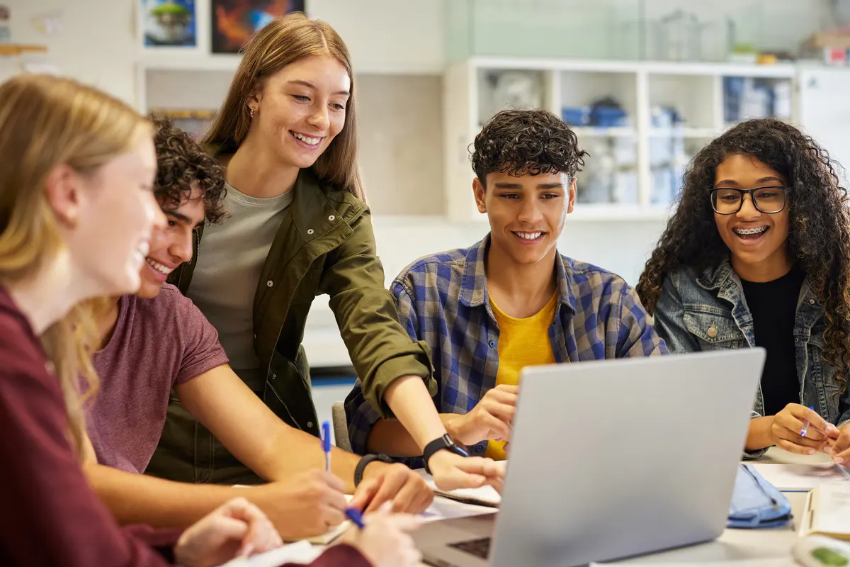Young learners working together at a laptop